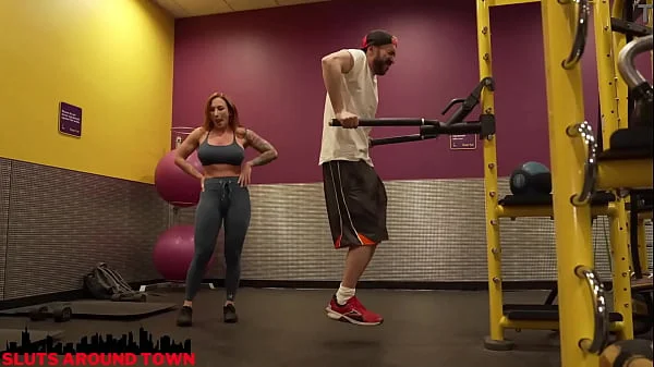 Personal trainer gives private lesson to guy at the gym