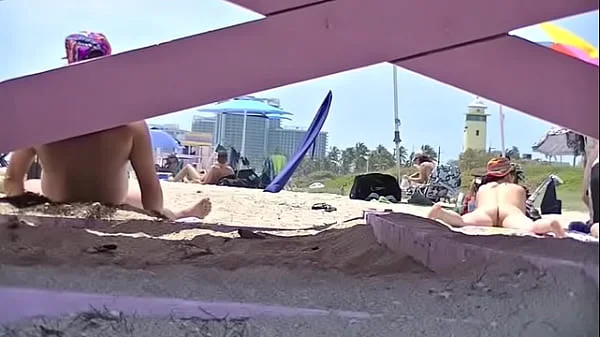 Exhibitionist Wife 63 - Tatiana teasing NUDE BEACH VOYEUR cocks while her hubby takes a nap!