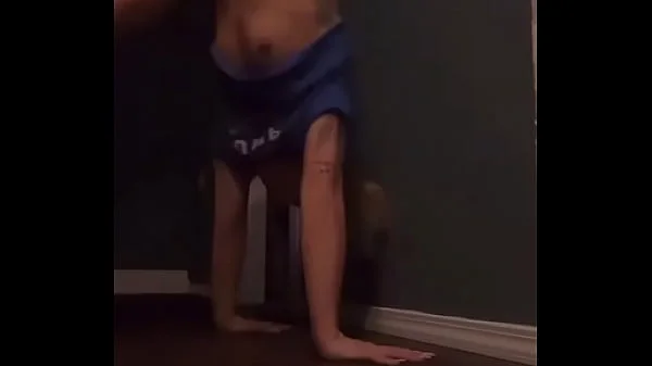 Teen doing a handstand with nip slip